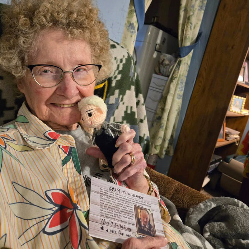 A customer holding her memorial doll and its message card