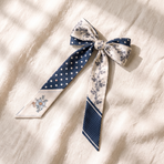 Hand-tied navy polka-dot and cream floral twilly bow